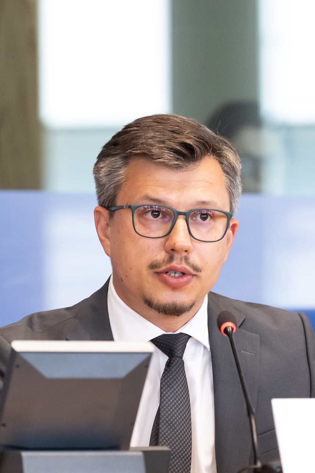 Dr Mykola Nazarov speaking at a microphone